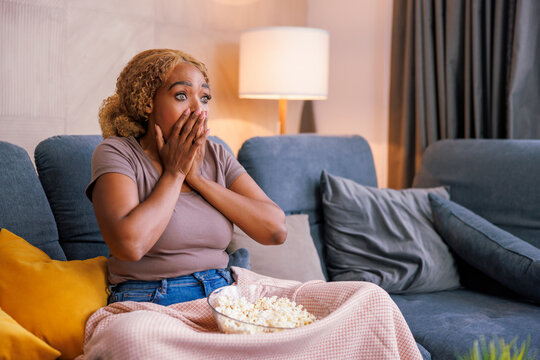 Woman Scared While Watching Horror Movie On TV At Home