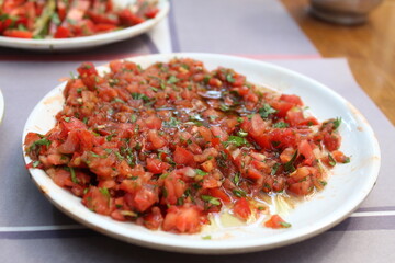 some salad and onions diced on white plates