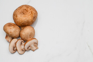 Grouping of whole and sliced portobello mushrooms