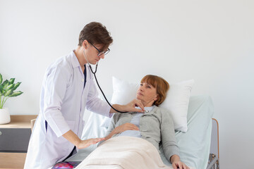 male doctor consulting senior old patient. Professional physician wearing white coat talking to mature woman.