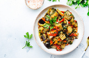 Vegetable stew, saute or caponata. Stewed eggplant with paprika, tomatoes, spices and herbs. White...