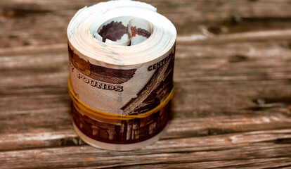 Egypt money roll pounds isolated on wooden background, 50 LE fifty Egyptian pounds cash money bills...