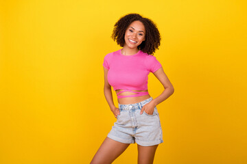Photo of lovely brunette lady wear crop top shorts isolated on vivid orange color background