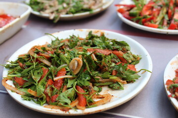 some salad and onions diced on white plates