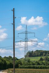 Obraz premium Electricity pylon for transmission and current transfer of high voltage through natural landscapes