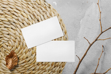 Clean minimal business card mockup on weave hyacinth with stick and leaf