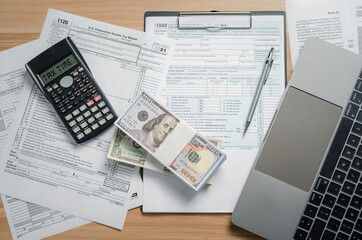 US Federal Income Tax Time filing forms, the Internal Revenue Service (IRS), pencils calculators...