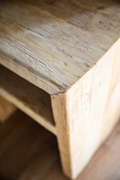 Detail of the corner of a handcrafted wooden bedside table