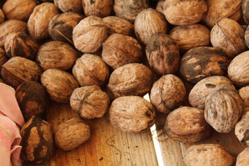 Some walnuts on a wooden bench