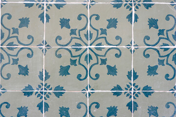 Vintage tiles of faded blue colours with floral ornate in Lisbon, Portugal