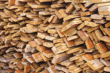 irregularly stacked timber abstract background, Old wooden boards preparing for the construction of...