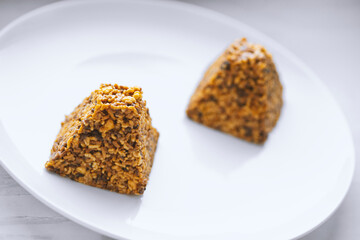 Candies made from various nuts served on white plate.