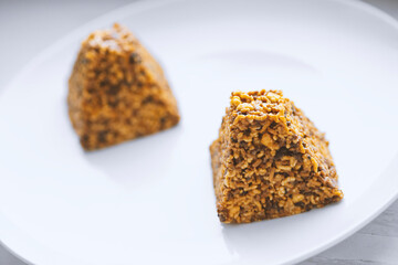 Candies made from various nuts served on white plate.