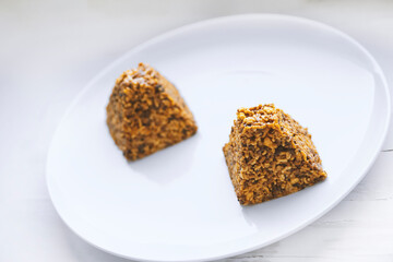 Candies made from various nuts served on white plate.