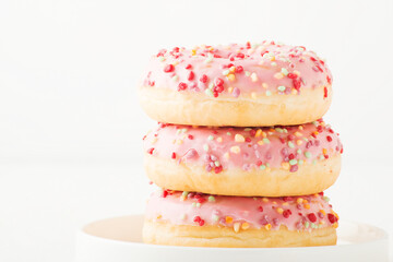 Pink donuts on a white background, close-up