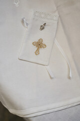 Orthodox cross for a baby before baptism on a beautiful festive cover with embroidery