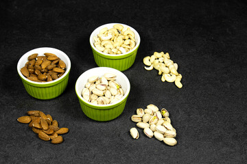 nuts (almonds,  pistachio, cashews) in bowls