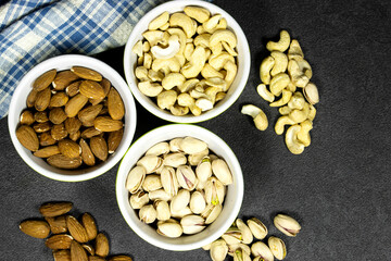 nuts (almonds,  pistachio, cashews) in bowls