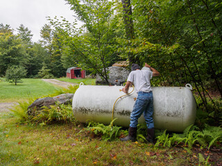 Man checking propane tank 
