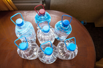 Bottles of water.. Stock of bottled water. Preparing for a food crisis. Selective focus