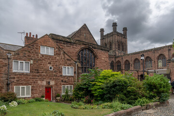 Fototapeta na wymiar downtown Chester in Cheshire with its historic red brick buildings and the 12th-century cathedral in the background under an overcast sky