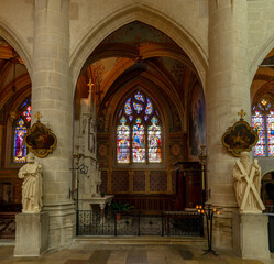 view of the altar and stained glass windows of a side chapel inside the Collegiale Notre Dame church in Dole