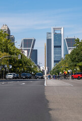 View of Madrid city road with skyscrapers in the background. It is the main avenue in the city full of traffic