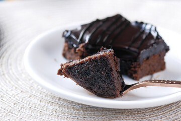 slow motion of pouring maple syrup on brownie on plate