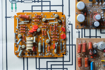Old printed circuit board background. Vintage circuit board with soldering trace. Backside brown...