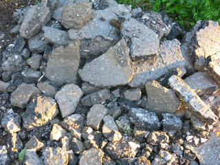 pieces of old removed broken asphalt are lying around in a heap