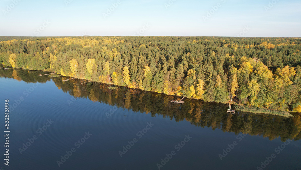 Wall mural Fishing pirs on lake shore