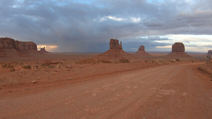 Fototapeta na wymiar Monument Valley Navajo Tribal Park in Arizona, USA. A storm and double rainbow over the Sentinel Mesa, West Mitten Butte, East Mitten Butte, Merrick Butte, and the Elephant Butte Monuments.