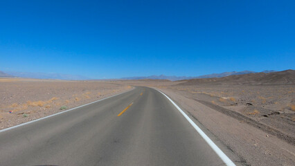 Fototapeta na wymiar Drive through Death Valley National Park in California, USA. Desert road in Death Valley.