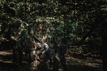 Eastern special forces soldier with rifle in woodland