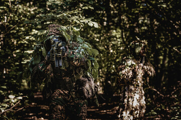 Eastern special forces soldier with rifle in woodland