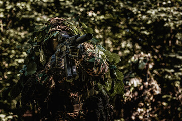 Eastern special forces soldier with rifle in woodland - 532516185