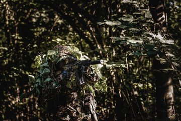 Eastern special forces soldier with rifle in woodland - 532516193