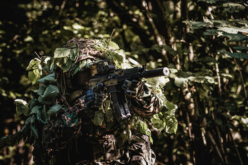Eastern special forces soldier with rifle in woodland - 532516196