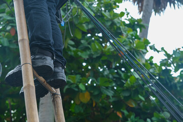 A worker trying to solve the electrical wires problem at Thailand