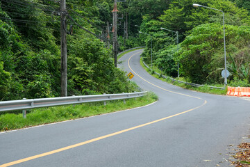 Empty highway in the rainforest mountains at Phuket, Thailand. No people and car