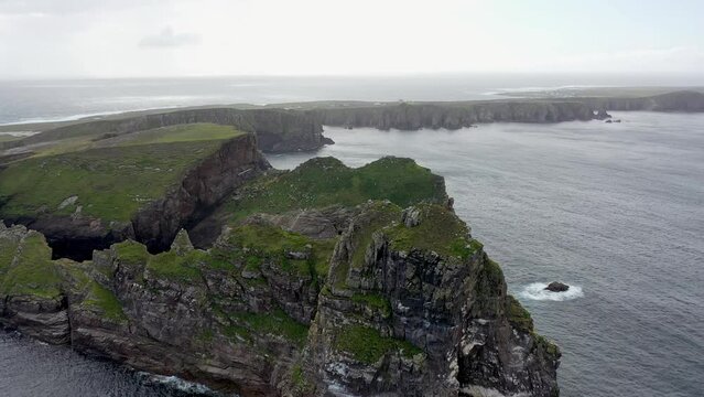 The cliffs and sea stacks An Tor Mor and the Wishing Stone at Port Challa on Tory Island, County Donegal, Ireland