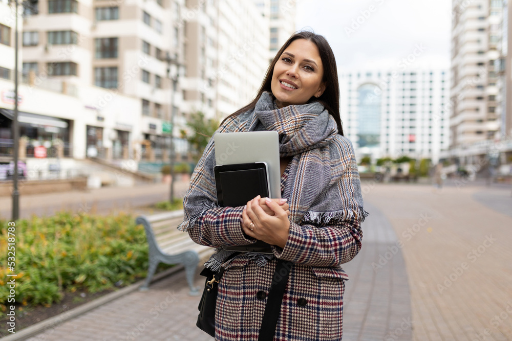 Wall mural portrait of a successful middle-aged woman businessman against the backdrop of urban development