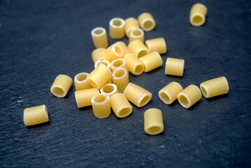 closeup of group of little pasta on chalkboard background
