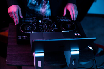 Fototapeta na wymiar DJ playing with mixing set up