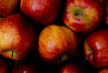 Fototapeta na wymiar Apple background of slightly spoiled apples, close up.
