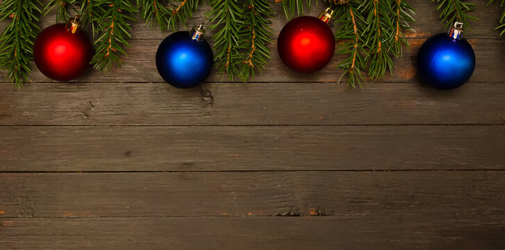 Two Red Christmas Balls,two Blue Balls And Fir Tree Branches.