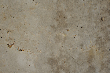 Texture of concrete with a crack in the middle. Close-up. Inclusions of sand of different colors. Old cracked surface.