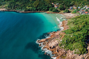 Naklejka na ściany i meble Beach, rocks and blue ocean in Brazil. Aerial view of tropical beach in Florianopolis