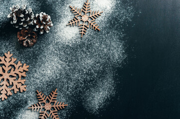 Flour and kitchen utensils on a dark table. Christmas baking. Food background. Winter holiday background. Template.