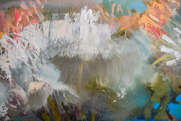 Close up detail of brushstrokes in acrylic and oil paint on an artist's palette.